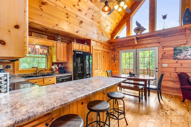 28 Upper Ridge Rd, Black Mountain, NC 28711 - kitchen with black appliances, wooden walls, a peninsula, light wood finished floors, and light countertops