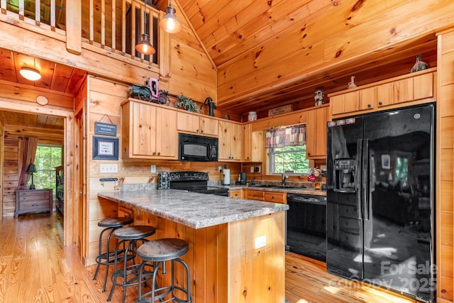28 Upper Ridge Rd, Black Mountain, NC 28711 - kitchen with black appliances, light wood finished floors, lofted ceiling, a peninsula, and wood ceiling