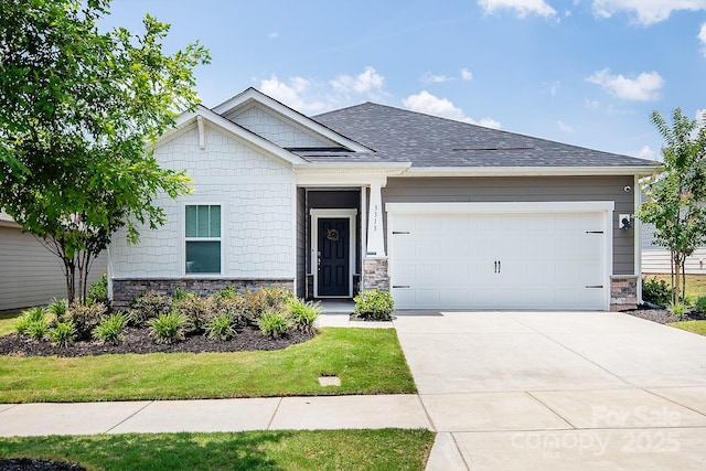 3313 Plum Dr, Monroe, NC 28110 - view of front of property featuring stone siding, a garage, concrete driveway, and roof with shingles