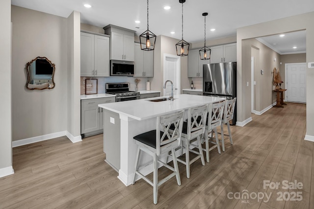 3313 Plum Dr, Monroe, NC 28110 - kitchen featuring stainless steel appliances, a kitchen breakfast bar, light wood-type flooring, decorative backsplash, and recessed lighting
