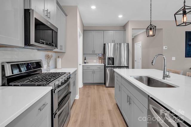 3313 Plum Dr, Monroe, NC 28110 - kitchen featuring appliances with stainless steel finishes, gray cabinets, light countertops, recessed lighting, and hanging light fixtures