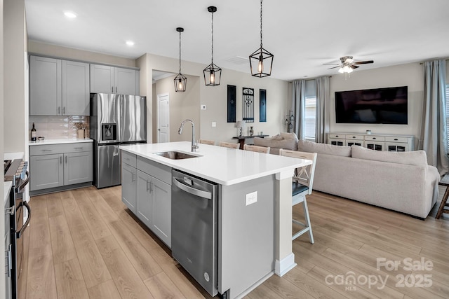 3313 Plum Dr, Monroe, NC 28110 - kitchen featuring appliances with stainless steel finishes, gray cabinets, light wood-style flooring, and recessed lighting