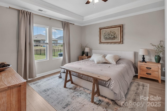 3313 Plum Dr, Monroe, NC 28110 - bedroom with ornamental molding, a raised ceiling, light wood finished floors, and ceiling fan