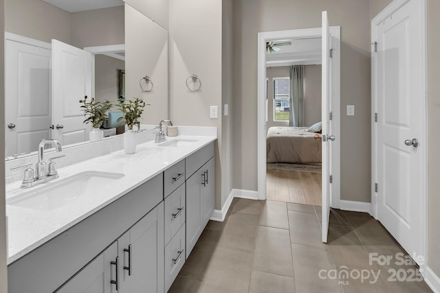 3313 Plum Dr, Monroe, NC 28110 - full bathroom with double vanity, connected bathroom, a ceiling fan, and tile patterned flooring