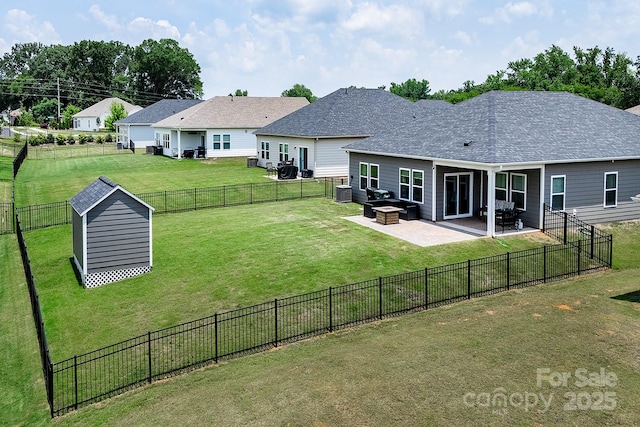 3313 Plum Dr, Monroe, NC 28110 - back of house featuring a storage unit, a patio, a fenced backyard, and a shingled roof