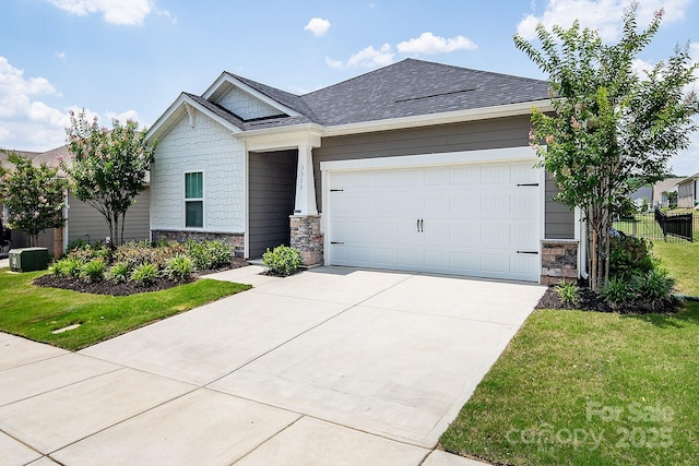 3313 Plum Dr, Monroe, NC 28110 - view of front of home with stone siding, driveway, a garage, and a shingled roof