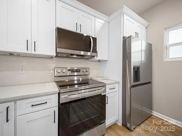8516 Paw Valley Ln, Charlotte, NC 28214 - kitchen featuring appliances with stainless steel finishes, white cabinets, light wood-style floors, and tasteful backsplash