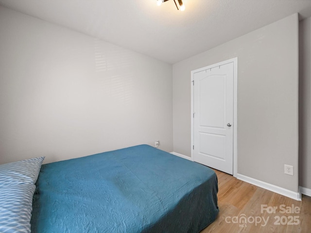 8516 Paw Valley Ln, Charlotte, NC 28214 - bedroom with light wood-style floors and baseboards