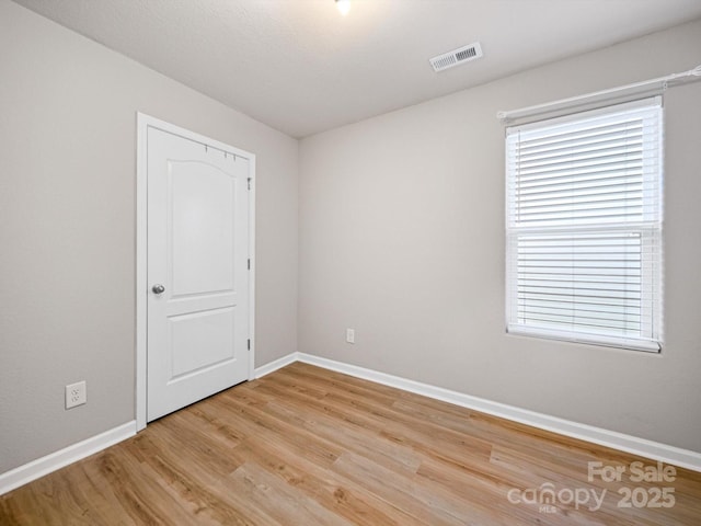 8516 Paw Valley Ln, Charlotte, NC 28214 - unfurnished room featuring light wood-style floors and healthy amount of natural light