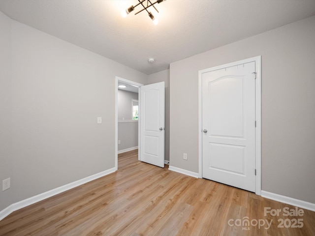 8516 Paw Valley Ln, Charlotte, NC 28214 - unfurnished bedroom with baseboards and wood finished floors