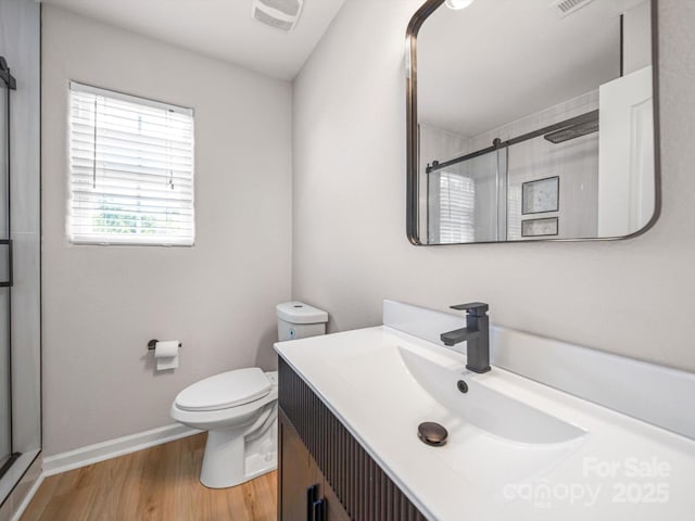 8516 Paw Valley Ln, Charlotte, NC 28214 - bathroom with a stall shower, vanity, and wood finished floors