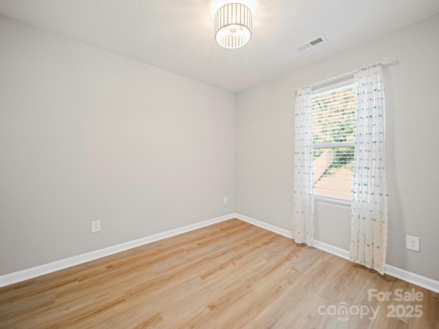 8516 Paw Valley Ln, Charlotte, NC 28214 - unfurnished room featuring wood finished floors and a chandelier