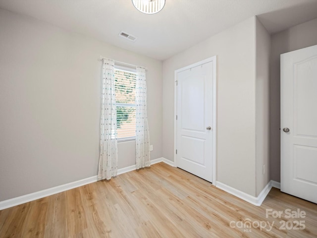 8516 Paw Valley Ln, Charlotte, NC 28214 - unfurnished bedroom with light wood finished floors and baseboards