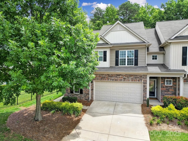 2203 Whitford Ln, Charlotte, NC 28210 - view of front of property featuring concrete driveway, board and batten siding, a garage, and stone siding