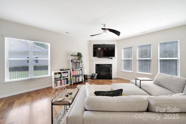 2203 Whitford Ln, Charlotte, NC 28210 - living room featuring a ceiling fan, a glass covered fireplace, and wood finished floors
