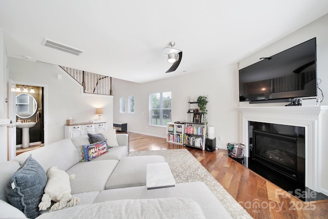 2203 Whitford Ln, Charlotte, NC 28210 - living room with wood finished floors, a glass covered fireplace, and stairs