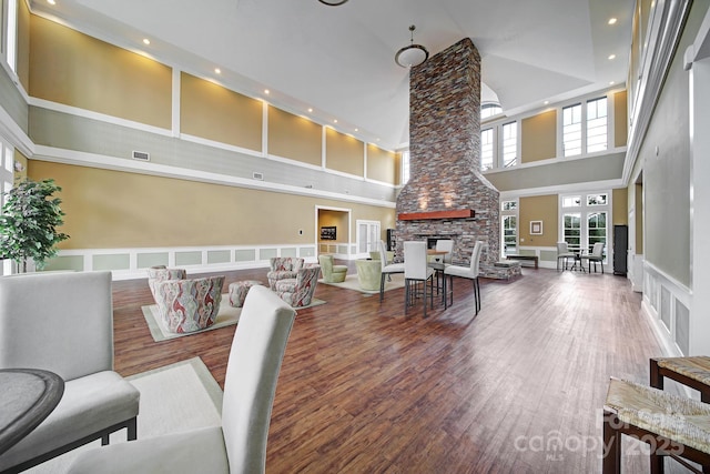 2203 Whitford Ln, Charlotte, NC 28210 - living area featuring a high ceiling, a decorative wall, wainscoting, recessed lighting, and a stone fireplace