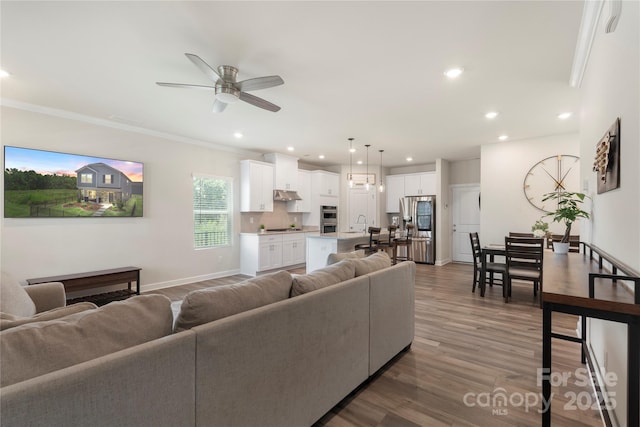 135 Orson Oaks Ln, Pineville, NC 28134 - living room with ceiling fan, crown molding, wood finished floors, and recessed lighting