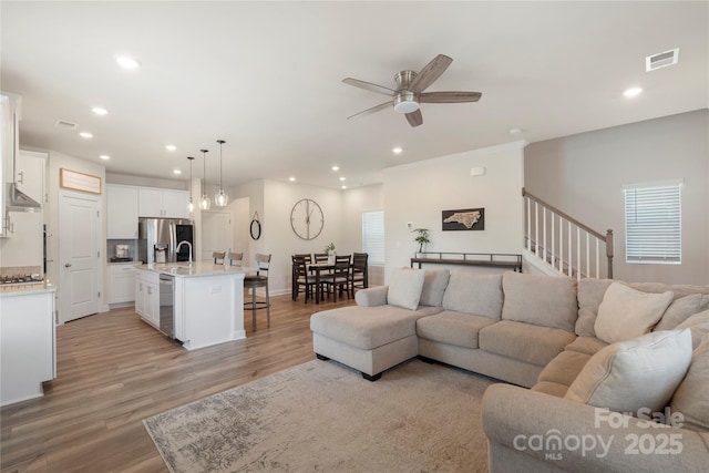 135 Orson Oaks Ln, Pineville, NC 28134 - living area featuring recessed lighting, a ceiling fan, light wood-style flooring, stairs, and ornamental molding