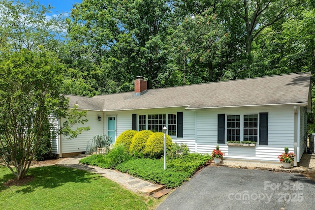10 Daniel Ln, Black Mountain, NC 28711 - ranch-style home with a chimney, a front lawn, and roof with shingles