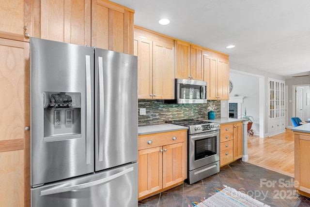 10 Daniel Ln, Black Mountain, NC 28711 - kitchen with appliances with stainless steel finishes, light brown cabinetry, light countertops, decorative backsplash, and recessed lighting