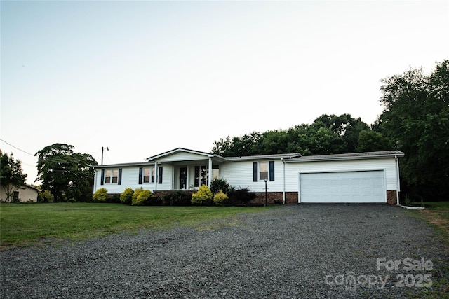 34107 Watson Rd, Albemarle, NC 28001 - ranch-style home with gravel driveway, a garage, brick siding, and a front yard