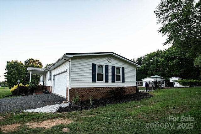34107 Watson Rd, Albemarle, NC 28001 - view of side of home featuring an attached garage and gravel driveway