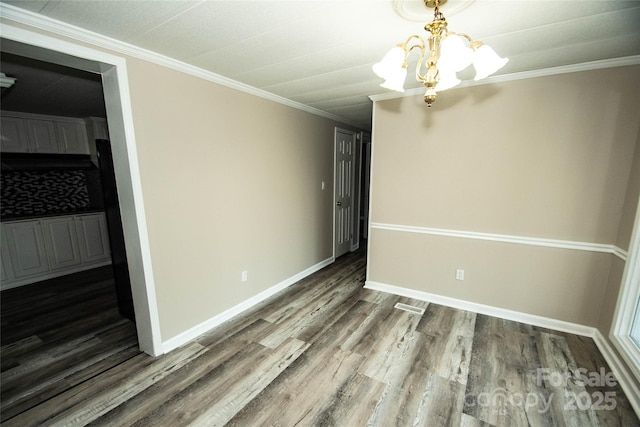 34107 Watson Rd, Albemarle, NC 28001 - empty room featuring wood finished floors, crown molding, and a chandelier