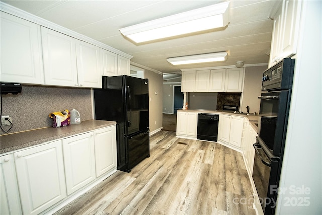 34107 Watson Rd, Albemarle, NC 28001 - kitchen featuring black appliances, white cabinetry, decorative backsplash, ornamental molding, and light wood-style floors