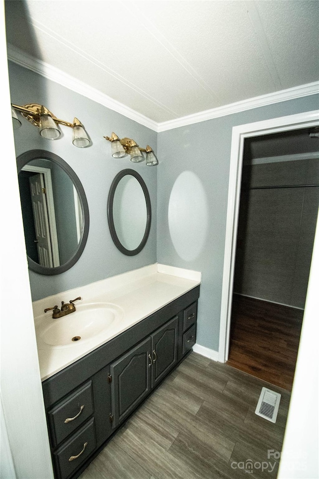 34107 Watson Rd, Albemarle, NC 28001 - bathroom with crown molding, vanity, and wood finished floors