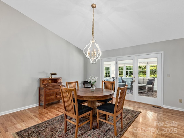 189 Cove Loop Rd, Hendersonville, NC 28739 - dining room featuring light wood finished floors, a chandelier, and high vaulted ceiling