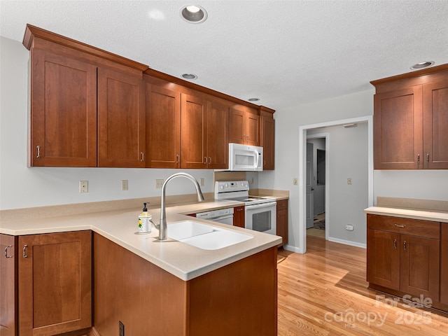 189 Cove Loop Rd, Hendersonville, NC 28739 - kitchen featuring white appliances, light countertops, a textured ceiling, recessed lighting, and light wood-type flooring