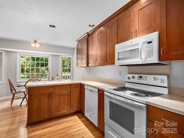 189 Cove Loop Rd, Hendersonville, NC 28739 - kitchen featuring white appliances, brown cabinets, a peninsula, a textured ceiling, and recessed lighting