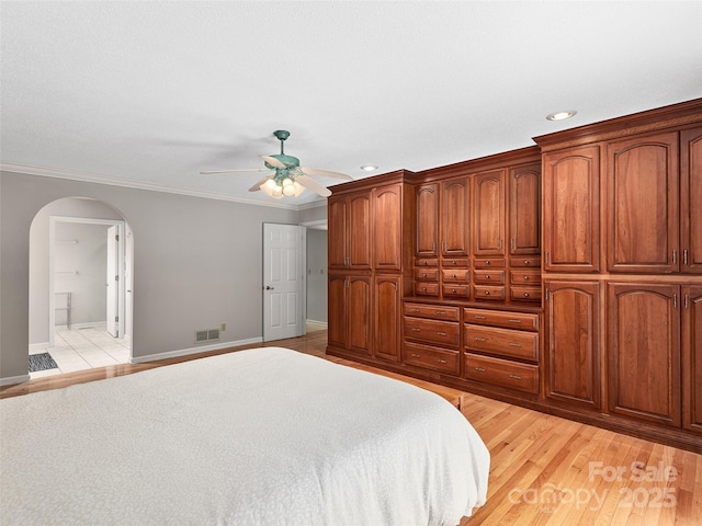 189 Cove Loop Rd, Hendersonville, NC 28739 - bedroom with arched walkways, ornamental molding, light wood-style floors, recessed lighting, and connected bathroom