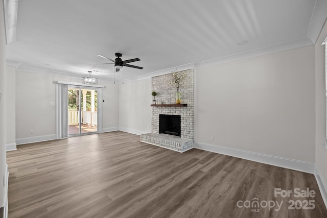 7219 Spring Morning Ln, Charlotte, NC 28227 - unfurnished living room with a ceiling fan, wood finished floors, crown molding, and a brick fireplace