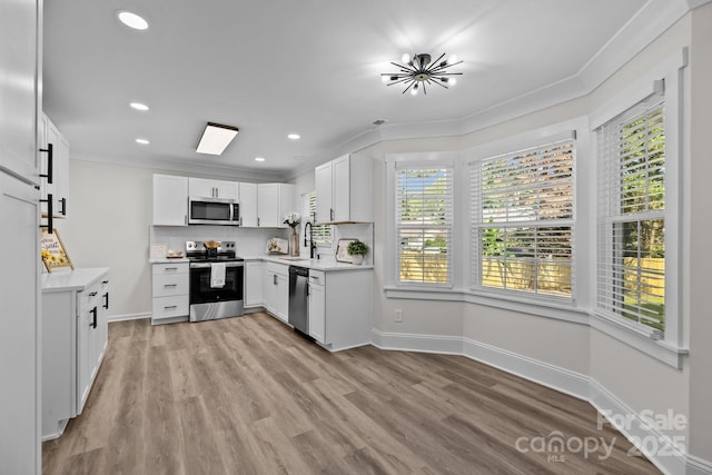 7219 Spring Morning Ln, Charlotte, NC 28227 - kitchen with stainless steel appliances, ornamental molding, light countertops, light wood-type flooring, and recessed lighting