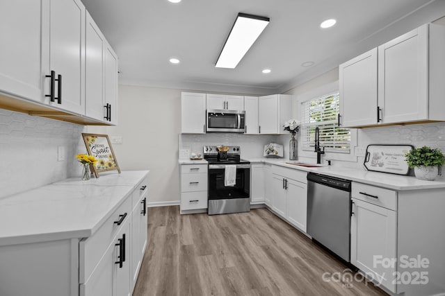 7219 Spring Morning Ln, Charlotte, NC 28227 - kitchen with stainless steel appliances, backsplash, recessed lighting, light wood finished floors, and white cabinets