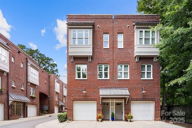 106 N Laurel Ave Unit 118, Charlotte, NC 28207 - townhome / multi-family property with brick siding, concrete driveway, and a garage