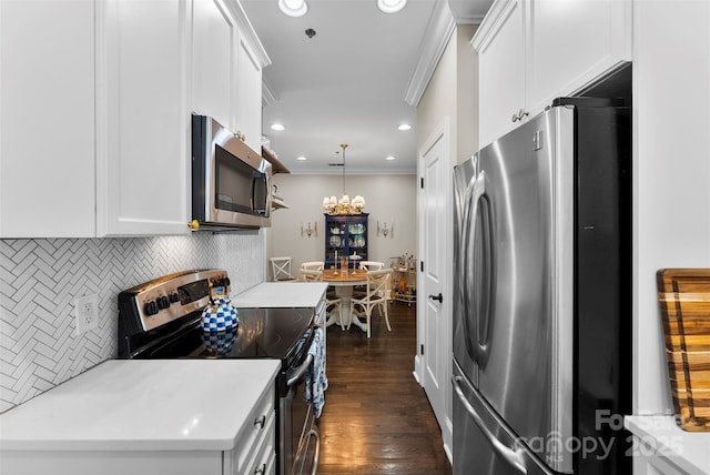 106 N Laurel Ave Unit 118, Charlotte, NC 28207 - kitchen with stainless steel appliances, ornamental molding, tasteful backsplash, white cabinetry, and light countertops