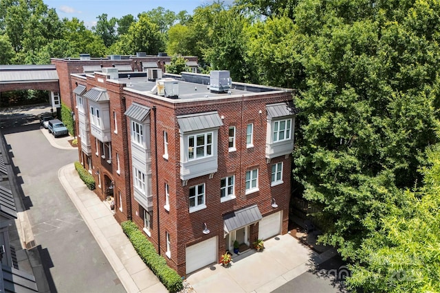 106 N Laurel Ave Unit 118, Charlotte, NC 28207 - view of property featuring an attached garage and concrete driveway