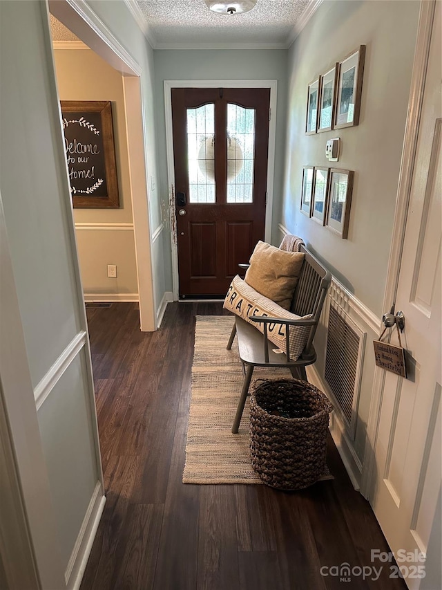 3210 Crow Row, Monroe, NC 28112 - entrance foyer featuring dark wood finished floors, crown molding, and a textured ceiling