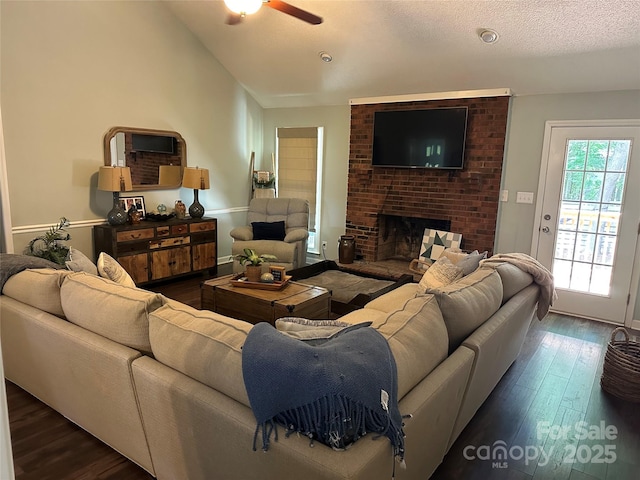 3210 Crow Row, Monroe, NC 28112 - living room with dark wood-type flooring, a ceiling fan, lofted ceiling, and a fireplace