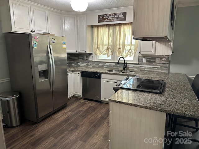 3210 Crow Row, Monroe, NC 28112 - kitchen featuring appliances with stainless steel finishes, white cabinetry, decorative backsplash, and dark wood-type flooring