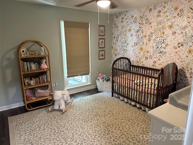 3210 Crow Row, Monroe, NC 28112 - bedroom with wood finished floors, a crib, and a ceiling fan