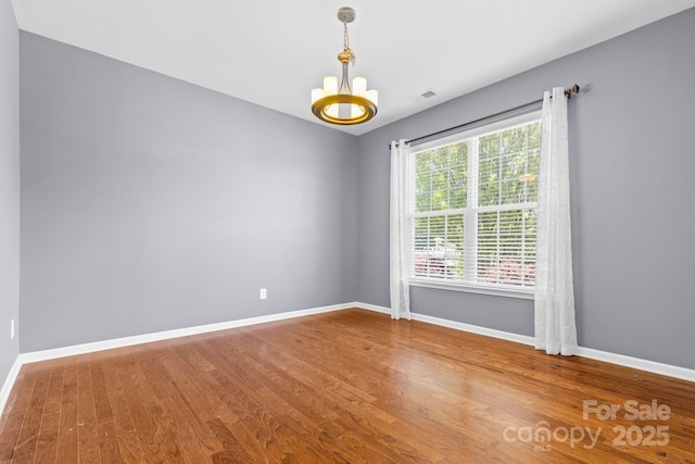 159 E Warfield Dr, Mooresville, NC 28115 - empty room featuring a chandelier and wood finished floors