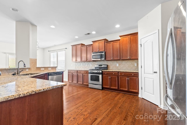 159 E Warfield Dr, Mooresville, NC 28115 - kitchen with stainless steel appliances, light stone countertops, dark wood-style floors, backsplash, and recessed lighting
