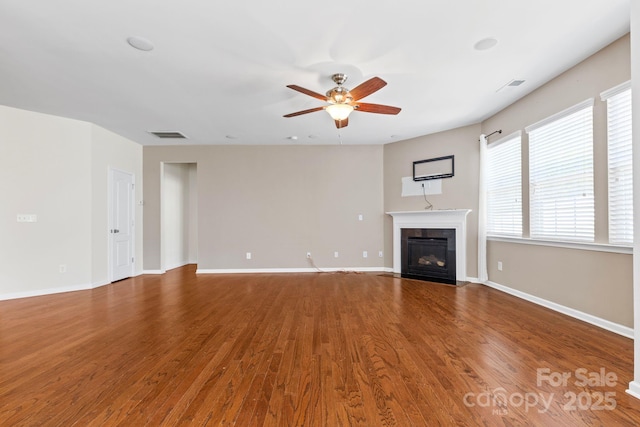 159 E Warfield Dr, Mooresville, NC 28115 - unfurnished living room featuring a fireplace with flush hearth, ceiling fan, and wood finished floors