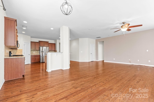 159 E Warfield Dr, Mooresville, NC 28115 - unfurnished living room with wood finished floors, ceiling fan, and recessed lighting