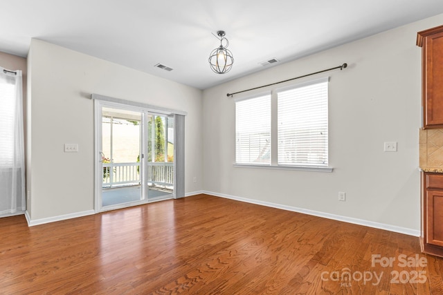 159 E Warfield Dr, Mooresville, NC 28115 - spare room featuring wood finished floors and plenty of natural light