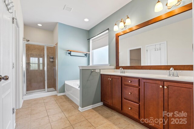 159 E Warfield Dr, Mooresville, NC 28115 - bathroom with a bath, a stall shower, double vanity, tile patterned floors, and recessed lighting